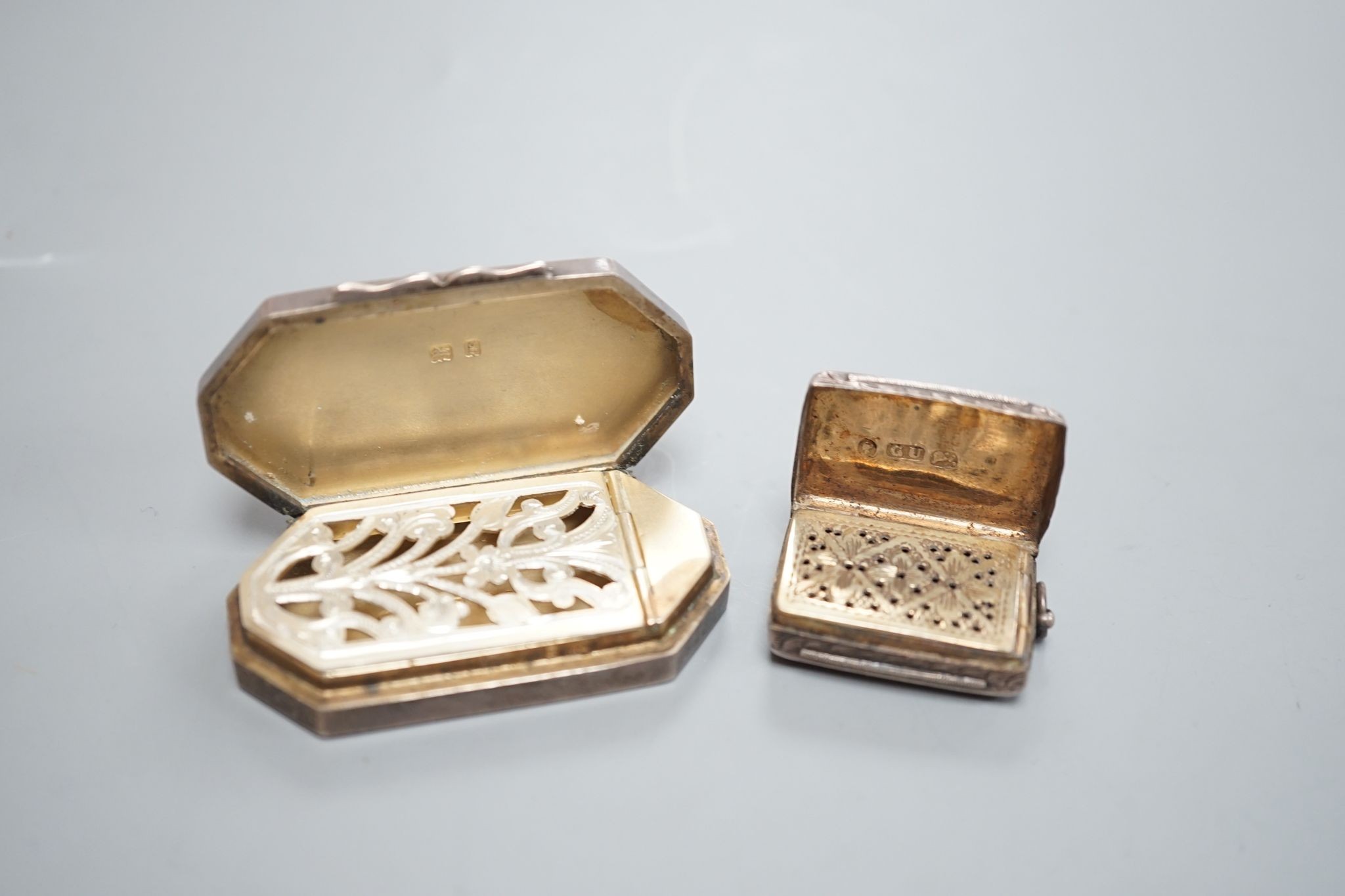 An Edwardian silver octagonal vinaigrette, with engraved sunburst decoration, maker, B.C Birmingham, 1906, 51mm and a smaller earlier vinaigrette by George Unite.